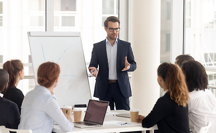 Male business coach speaker in suit give flipchart presentation, speaker presenter consult